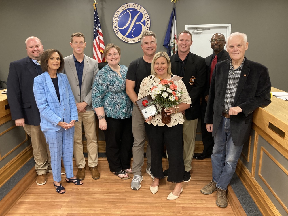 Nicole Sergent with her husband, board members, bcs superintendent, and principal trent Sherman