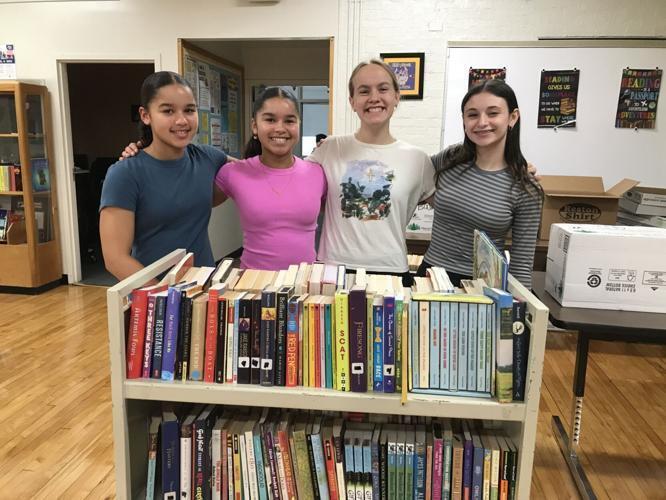 Grace and Sydney Young, Fiona Hall and Bailey Carrell with books from the Hedgesville Middle School book fair.