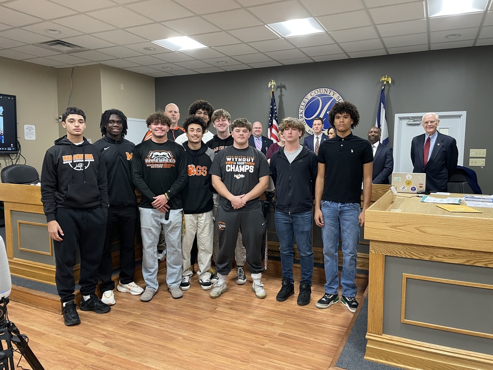 martinsburg football team with board members and Dr. Saxe. 