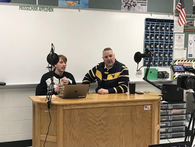 image of steven askin and history teacher eric brown recording a podcast at a desk