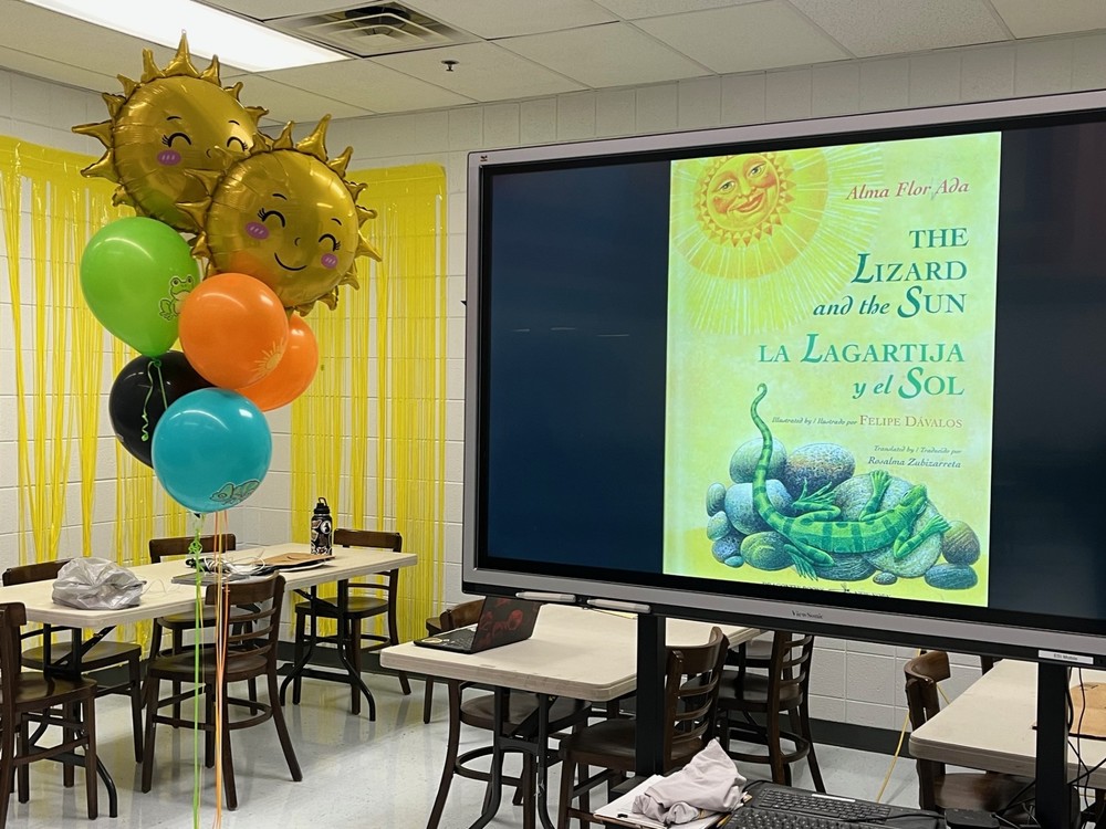 A picture on the screen of the book that was read at the event called "The Lizard and the Sun"