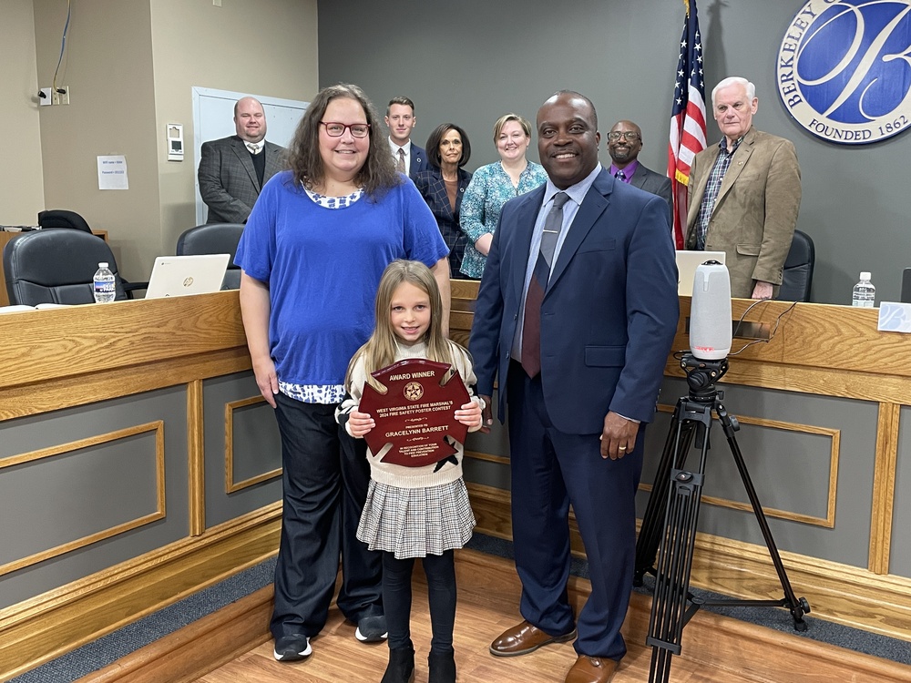 Gracelynn, Paul Baker, board members, and superintendent