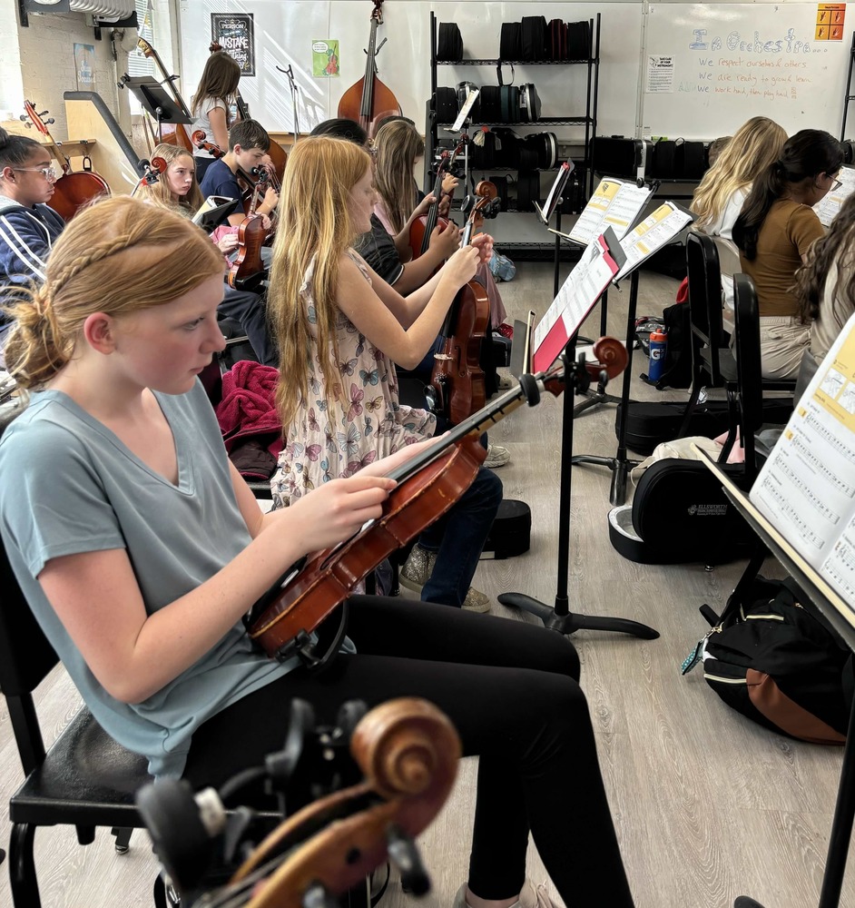 students tuning thier violins