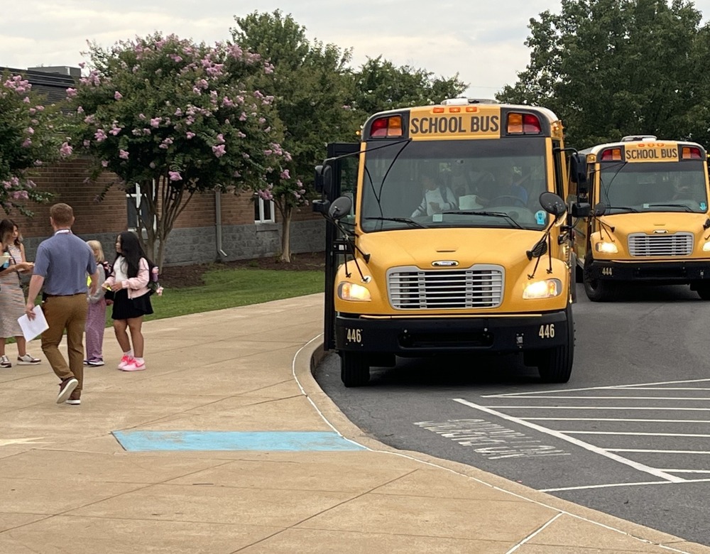 school buses pull up to the front of the school on the first day