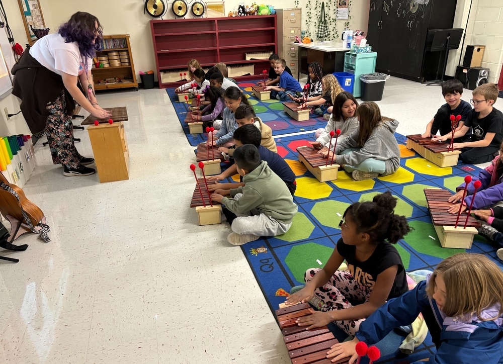 students playing on xylophones