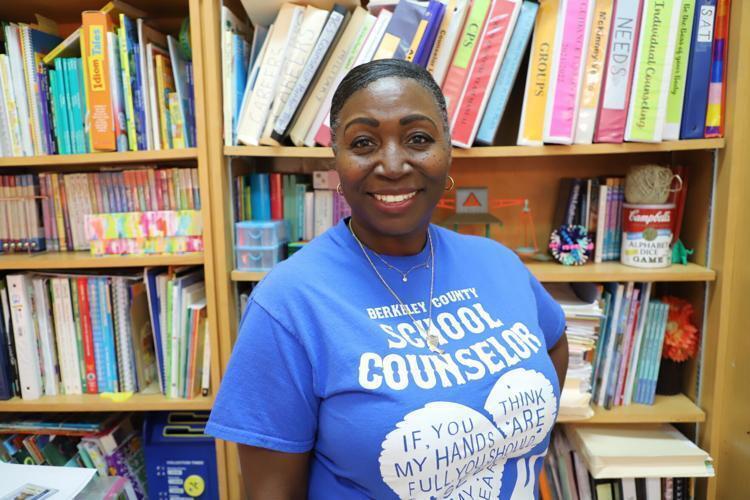 image of jodi williams standing in front of a bookcase