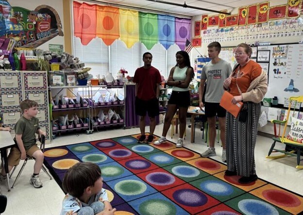 Joshua Menocal, Jocelyn Winston, Lochlynn Campbell and Elizabeth Sanchez talking to a kindergarten class at Rosemont Elementary School