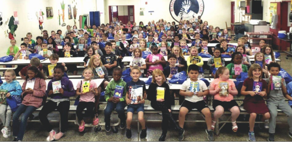 A group of second grade students from Berkeley Heights are shown displaying one of the books they recieved.