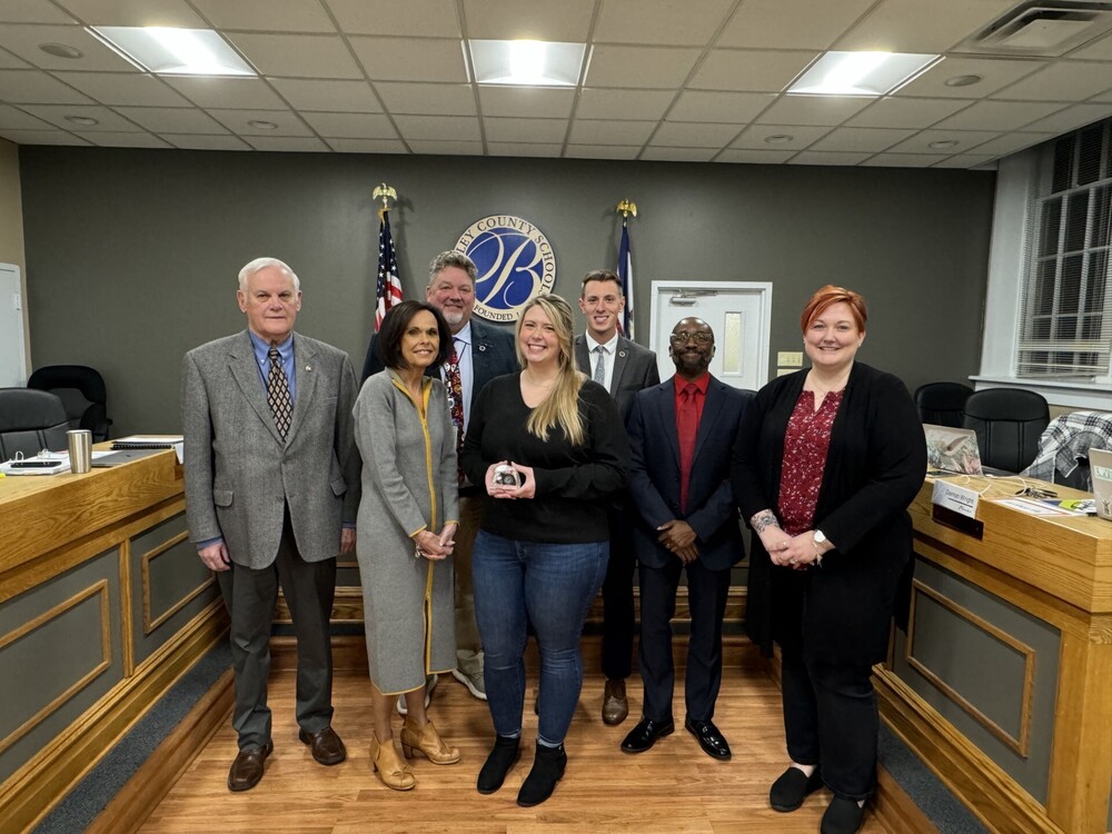image of ace award winner hannah horner standing with members of the board of education