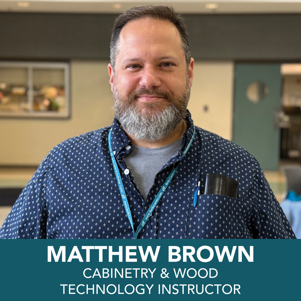 A person is shown wearing a blue patterned shirt with a lanyard around their neck and a pen in the shirt pocket. The background appears to be an indoor setting with blurred elements. At the bottom of the image, text reads: "MATTHEW BROWN CABINETRY & WOOD TECHNOLOGY INSTRUCTOR."