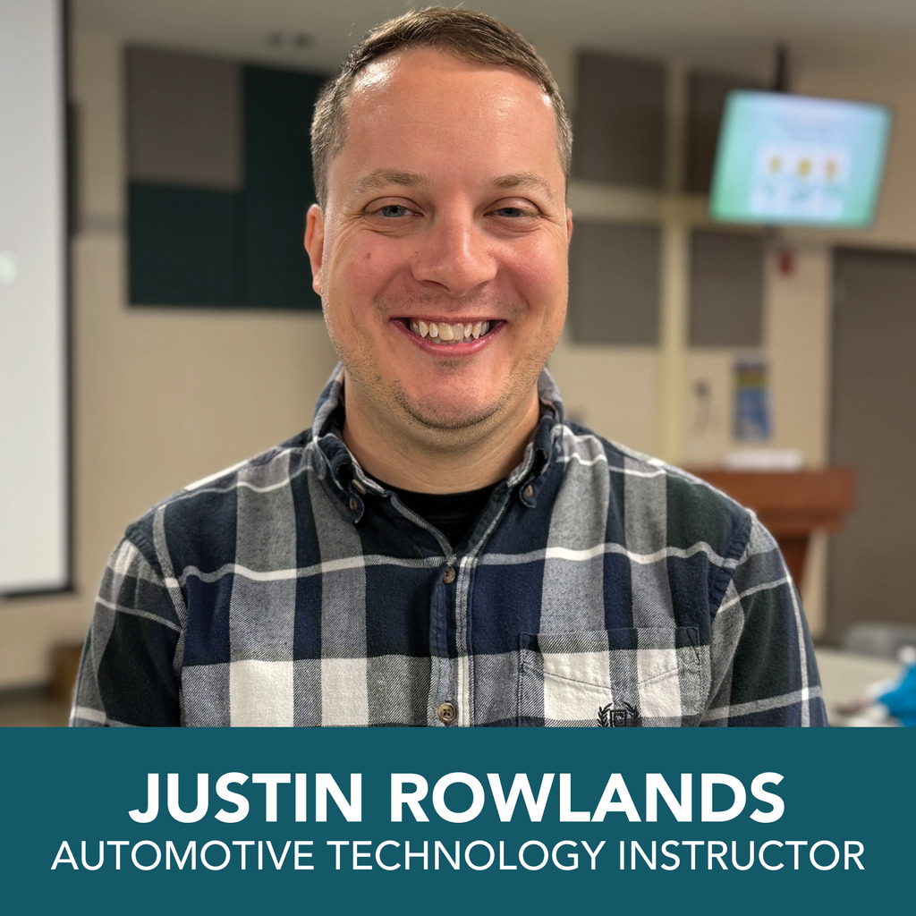 A person with a blurred face stands in what appears to be a classroom or lecture hall. They are wearing a blue and white plaid shirt. At the bottom of the image, text reads: "JUSTIN ROWLANDS AUTOMOTIVE TECHNOLOGY INSTRUCTOR."