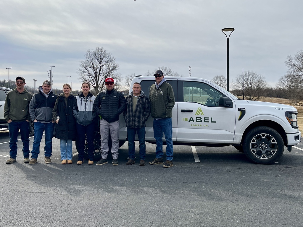 I.B. Abel crew members stand in front of a branded company truck during the site visit.