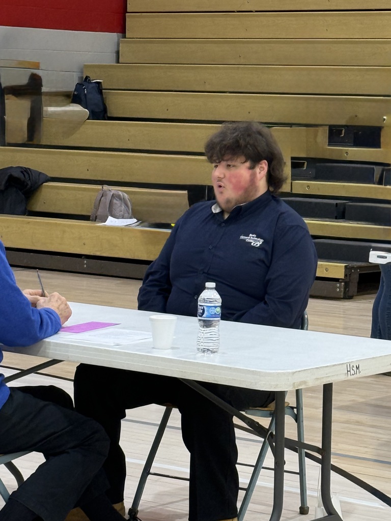 Service Occupations student answers questions during a mock interview at an Employability Expo, practicing communication and interview skills.