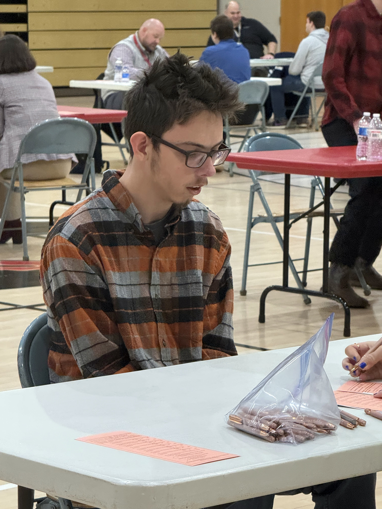 Service Occupations student participates in a mock interview while an interviewer reviews notes during an Employability Expo event.