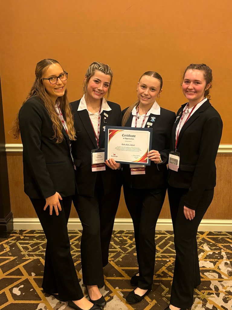Four BCTC HOSA students in professional attire pose together holding a certificate of appreciation at the Penn HOSA State Leadership Conference.