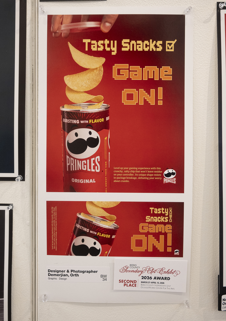 Red graphic design poster showing a can of chips with stacked chips above it and bold text reading “Game On.”