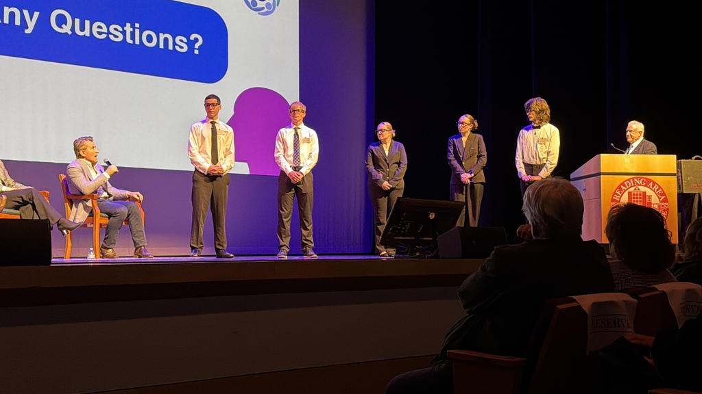 Robert Herjavec poses with BCTC students and staff in front of a Reading Area Community College banner.