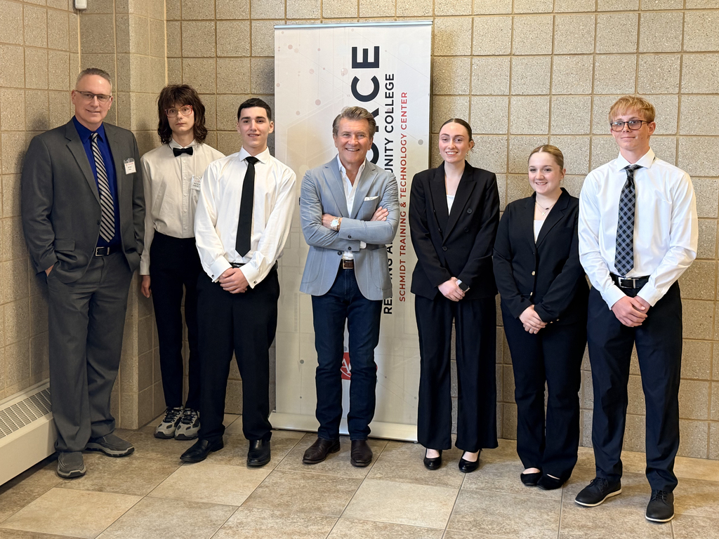 Robert Herjavec poses with BCTC students and staff in front of a Reading Area Community College banner.