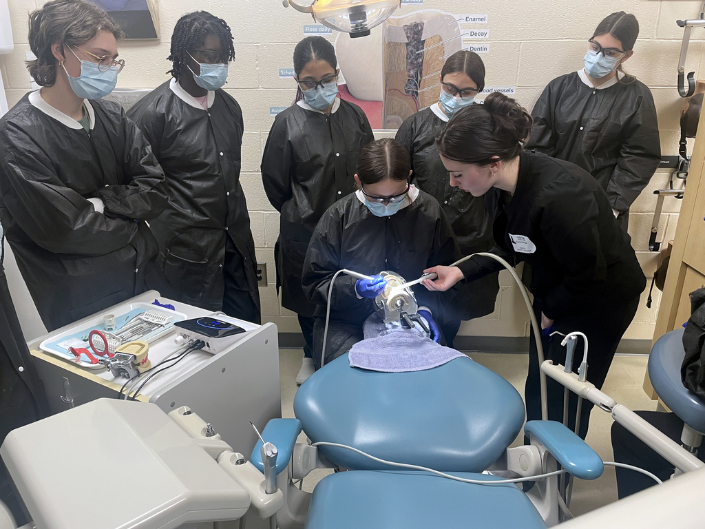 Dental Occupations students observe a guest demonstration using dental equipment on a mannequin in a BCTC classroom.