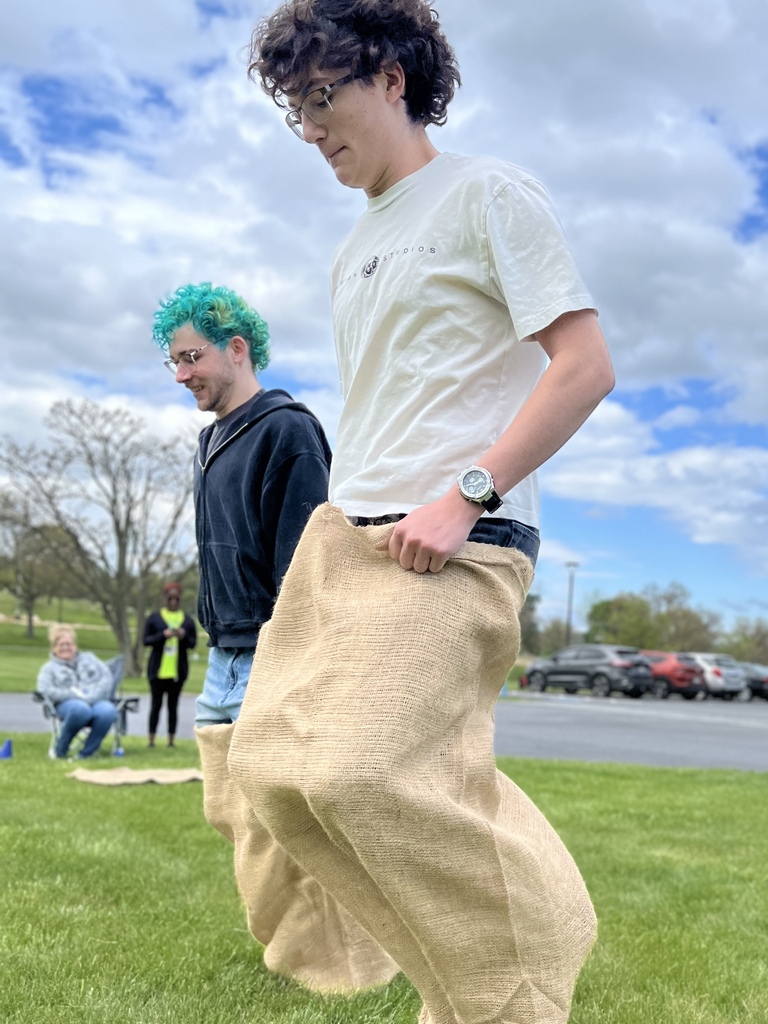 Students participate in a sack race on the grass outside BCTC.