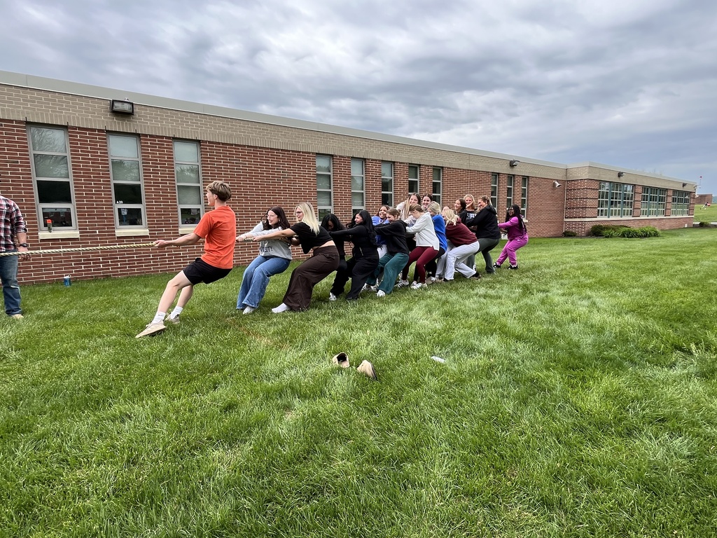 Group of students competes in tug-of-war on the grass outside BCTC.