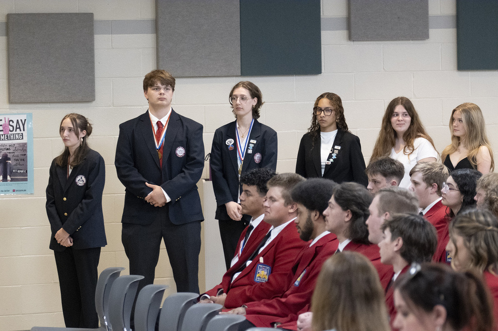 BCTC students stand and sit during the JOC meeting as student competition achievements are recognized