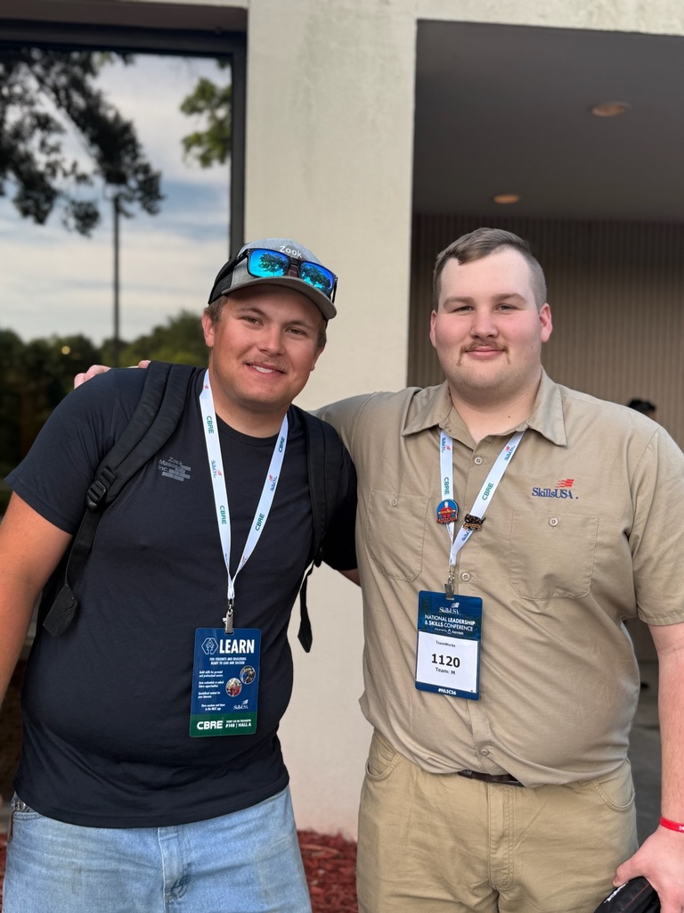 Two BCTC students wearing conference badges pose together outside during the SkillsUSA National Leadership & Skills Conference.