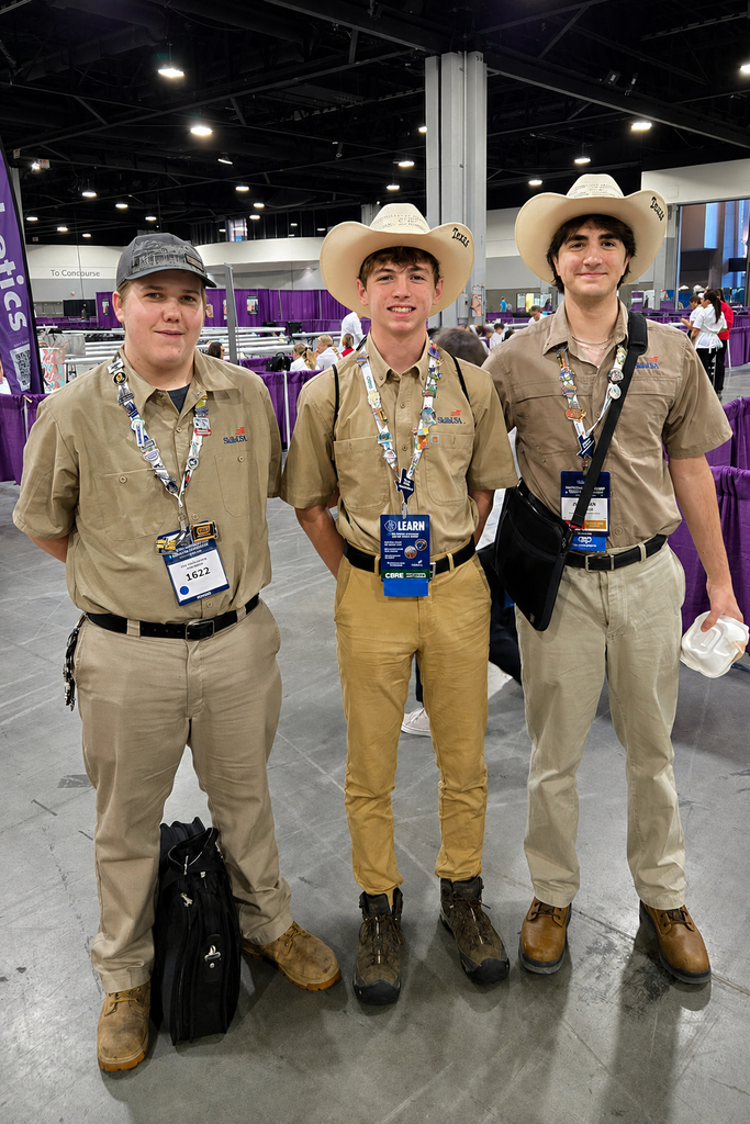 Three BCTC SkillsUSA competitors pose in tan uniforms and cowboy hats at the national conference.