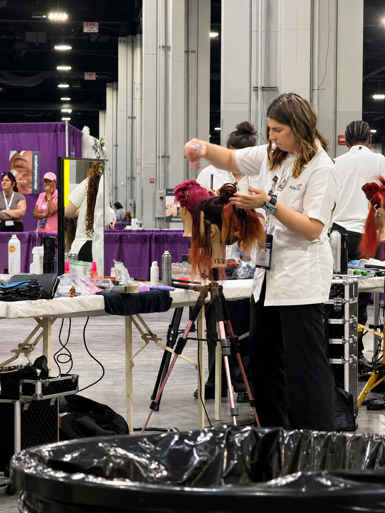 A BCTC SkillsUSA competitor styles a mannequin head during the cosmetology competition.