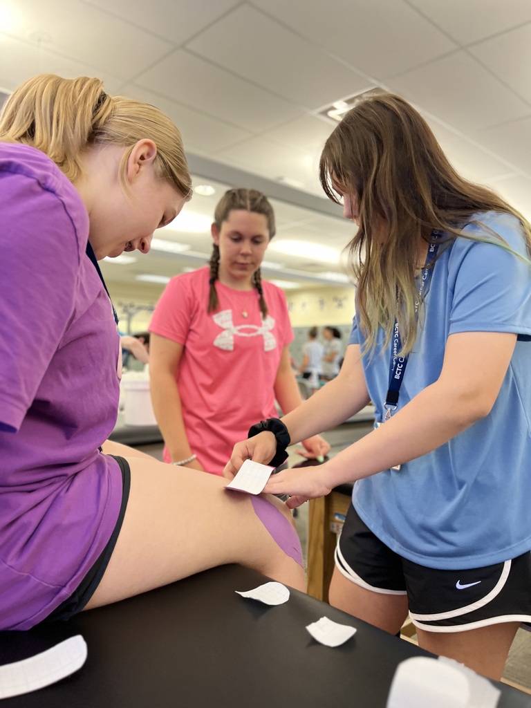 Career Camp participants practice applying athletic tape during a hands-on health skills activity.