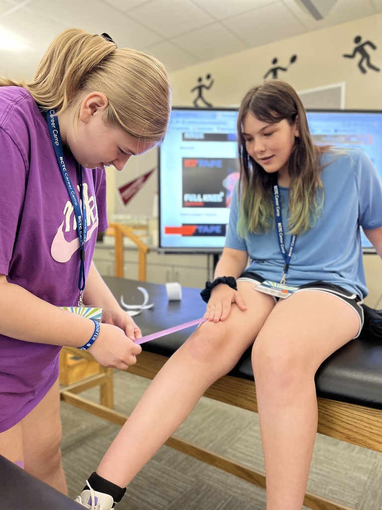 Career Camp participants practice athletic taping techniques on a classmate’s leg.