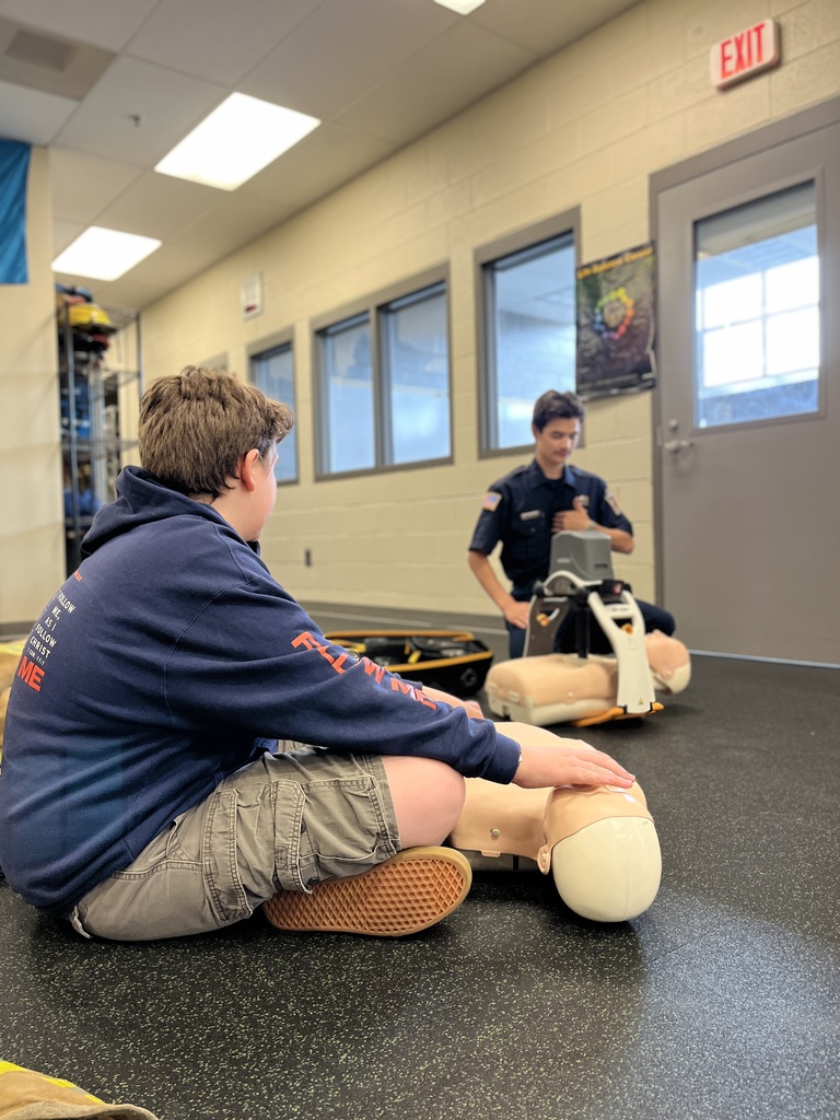 Career Camp participants practice CPR skills on training mannequins in a BCTC classroom.