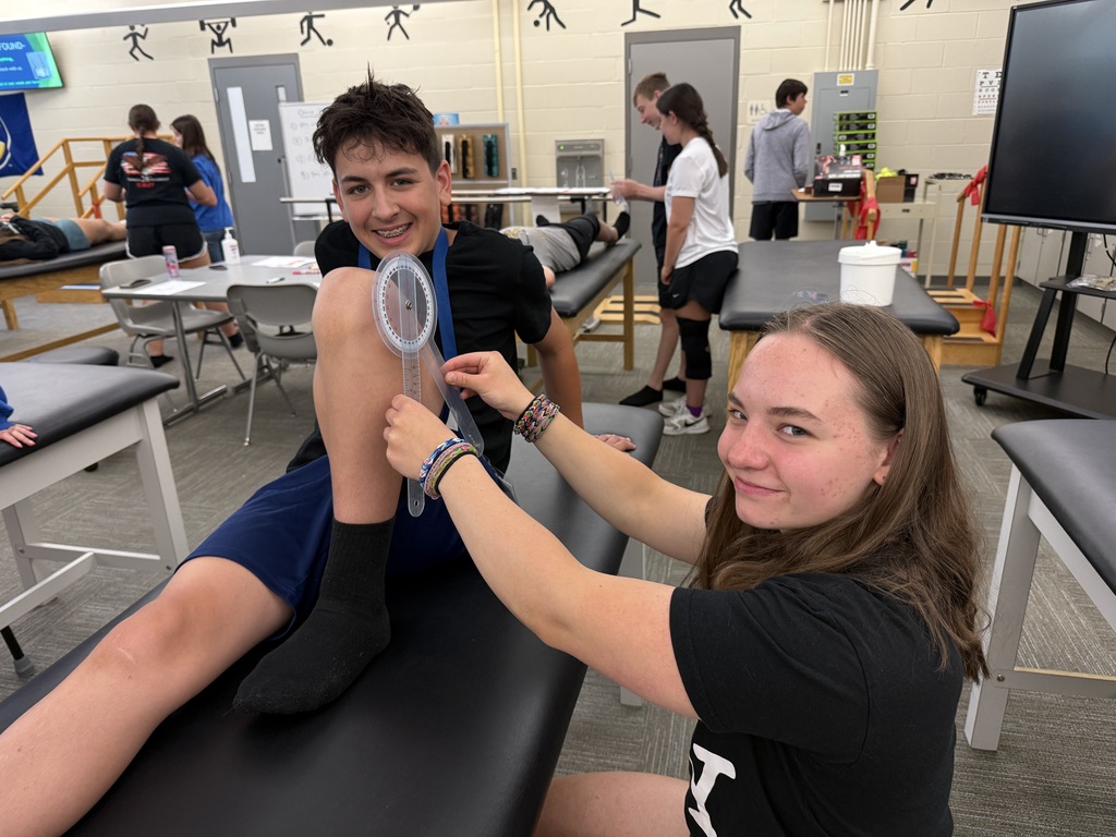 Career Camp participants practice measuring knee range of motion with a goniometer in a health skills lab.