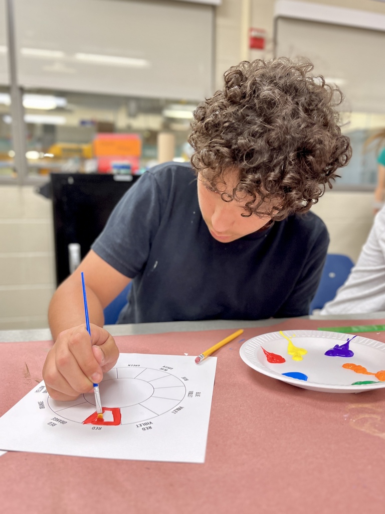 Career Camp participant paints a color wheel during a hands-on art and design activity.