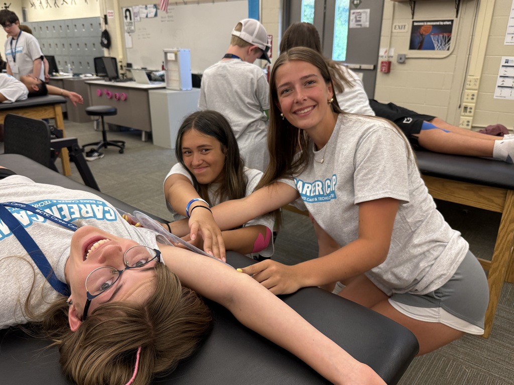 Career Camp participants smile while practicing health skills in a BCTC lab.