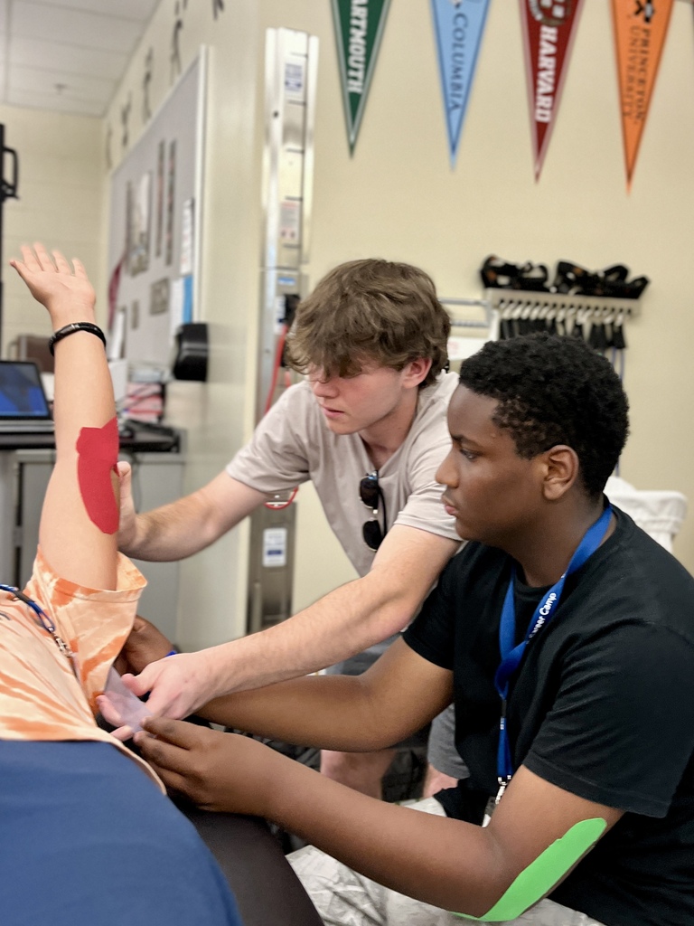 Career Camp participants practice applying athletic tape during a health skills activity.
