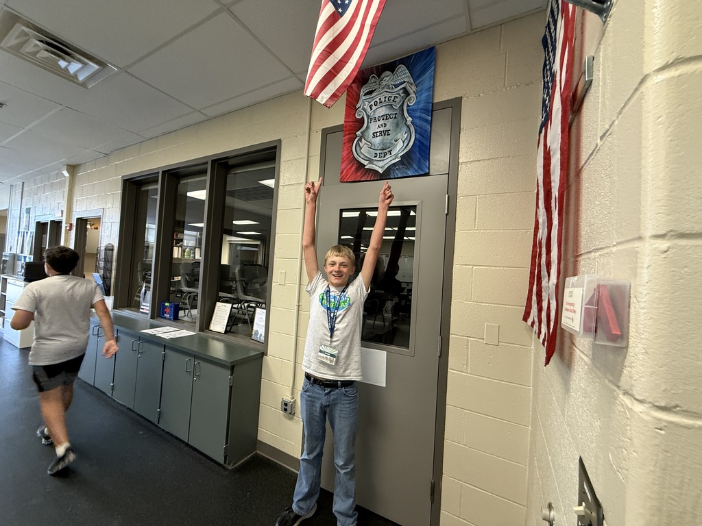 Career Camp participant poses with arms raised during a digital scavenger hunt challenge.