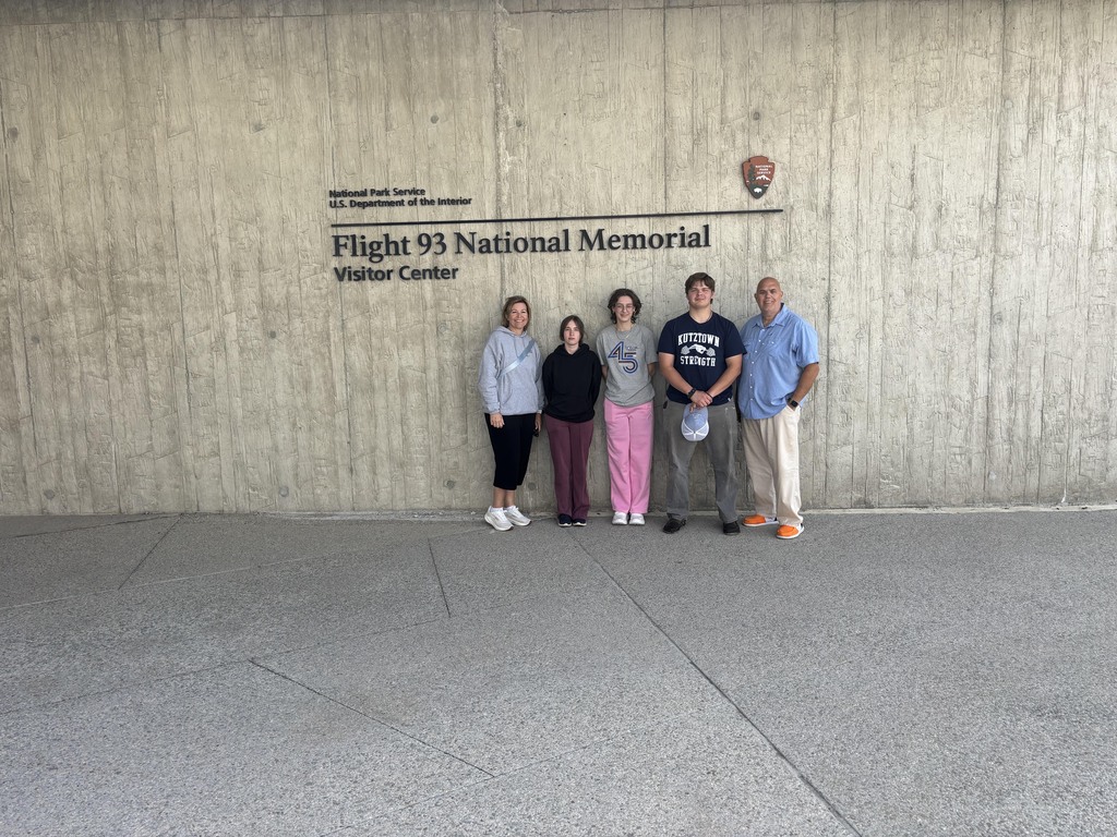 BCTC HOSA students and advisors stand together inside the Flight 93 National Memorial Visitor Center near a large wall sign.