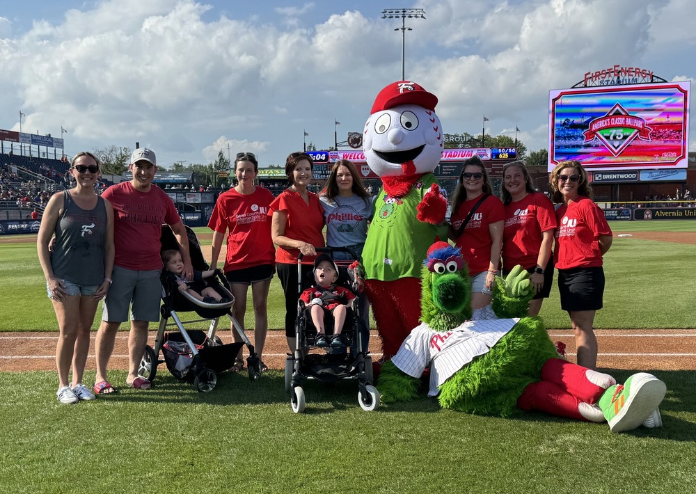 BCIU Reading Fightin Phils Night. EI Staff and Student with Family pictures with Screwball mascot and the Phillie Phanatic
