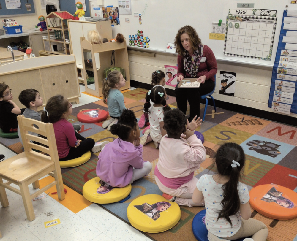 Dr. Reichard-Huff reading to a group of students