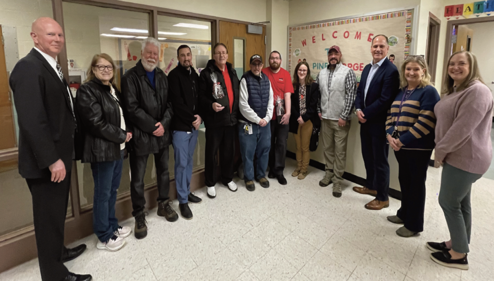 Group of Staff standing in line and smiling to celebrate honorees