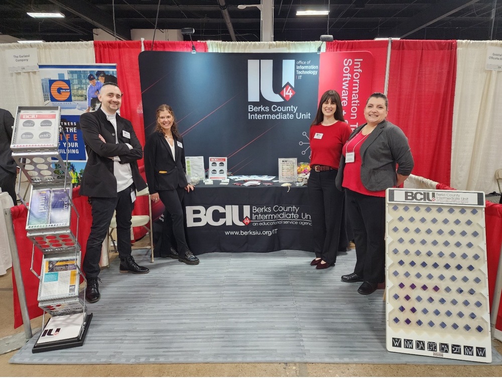 IT Staff in front of booth