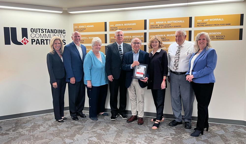 Jim Boscov receives the 2025 Outstanding Community Partner award in front of the Berks County Intermediate Unit’s Outstanding Community Partner award wall. From left to right: Dr. Jill Hackman, BCIU Executive Director; Scott Gruber, Executive Director of Economic Development, Our City Reading Inc.; Linda Lash, BCIU Board Treasurer; Gary McEwen, BCIU Board President; Jim Boscov; Judy Boscov; James Ulrich, BCIU Board Secretary; and Elizabeth Huhn, BCIU Board Vice President.