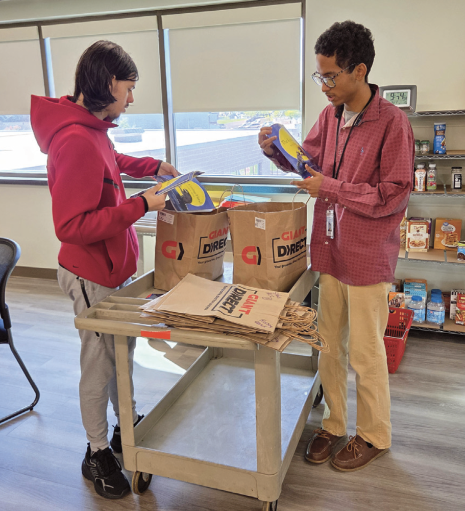 PAL Students Working Together to fill brown bags with items