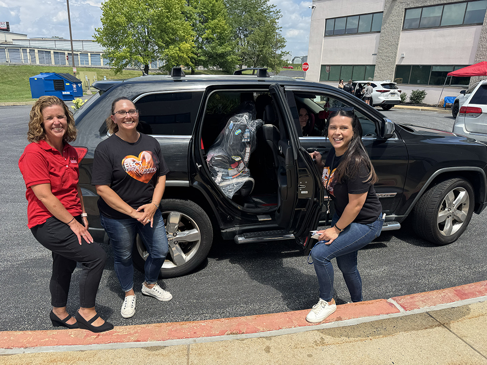 ELECT and ECSS Staff in front of Car with Car Seat