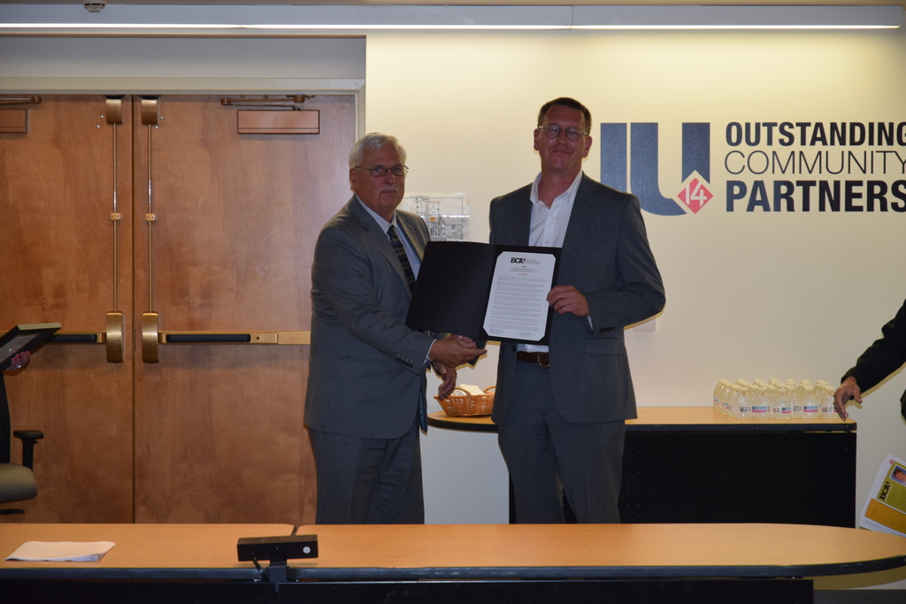 Mr. Mcewen and Mr. worrall holding certificate
