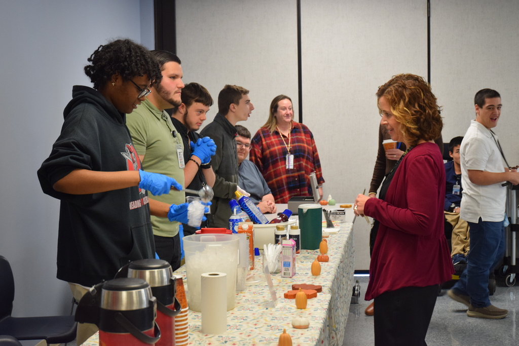 Dr. Reichard-Huff receiving coffee from student