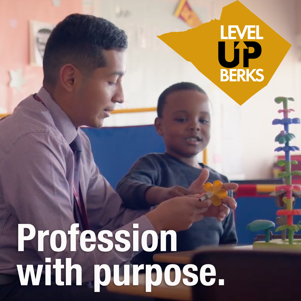 A male educator sits beside a young child in a classroom, guiding him as they build a structure with colorful interlocking pieces. The child smiles while holding a yellow flower-shaped piece. In the top right corner, a gold shape with the text "LEVEL UP BERKS" is displayed. The bottom text reads: "Profession with purpose."