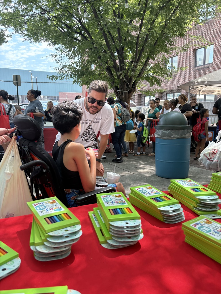 Zach Milch interacting with student at Back-to-School Giveaway event.