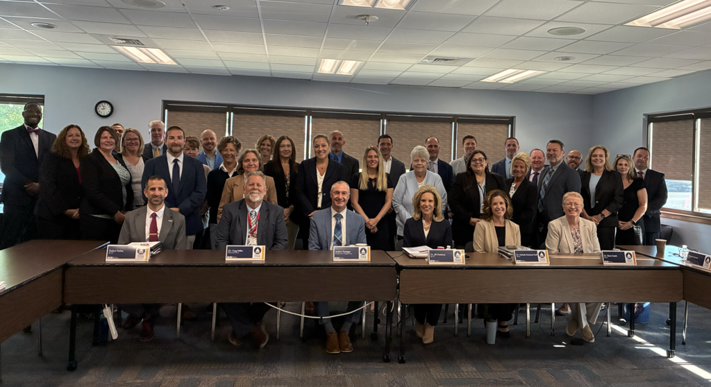 Group of individuals who attended the COLA meeting smiling at the camera